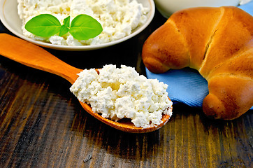 Image showing Curd on a wooden spoon on a board