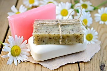 Image showing Soap with chamomile on a board