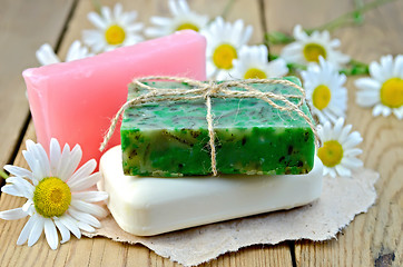 Image showing Soap homemade with chamomile on a board