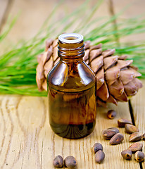 Image showing Oil with cedar cone and nuts on the board