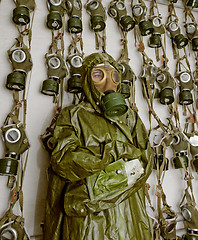 Image showing old military gas on a chemical protective suit woman 