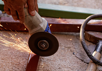 Image showing hand grinder saw the steel