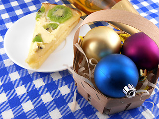 Image showing Christmas decoration with christmas balls and sweet kiwi cake