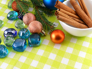 Image showing christmas decoration cinnamon baubles stones in yellow macro closeup