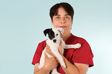 Image showing Woman holding puppy dog