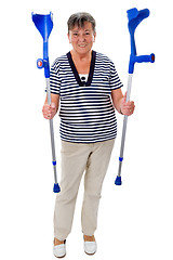 Image showing Elderly woman with crutches