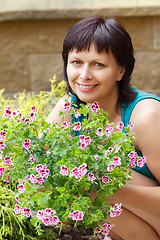 Image showing happy smiling middle age woman gardening