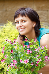 Image showing happy smiling middle age woman gardening