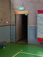 Image showing Illuminated green emergency exit 