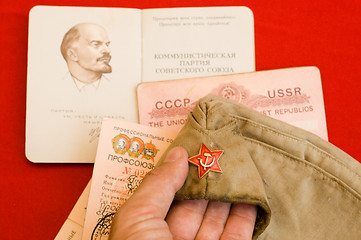 Image showing party card with forage cap in hand over red