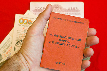 Image showing party card in hand over red