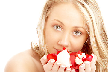 Image showing happy blond in spa with red and white petals