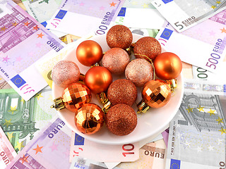Image showing Christmas balls set on white plate, dollar background