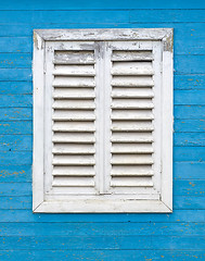 Image showing Old white window with wooden shutters.