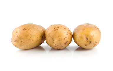 Image showing Three raw potatoes isolated on a white