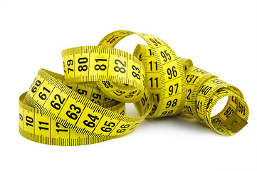 Image showing Curled yellow measuring tape on white background