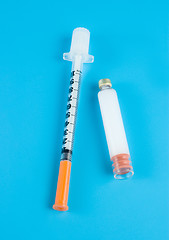 Image showing  Insulin and syringe on a blue background