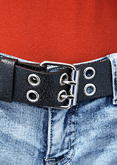 Image showing Black leather belt and orange shirt