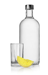 Image showing Bottle of vodka and lemon isolated