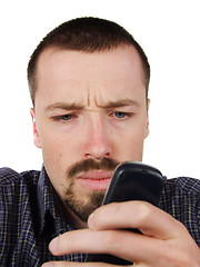 Image showing Young man typing a short text message