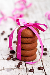 Image showing stack of chocolate cookies tied with pink ribbon and coffee bean