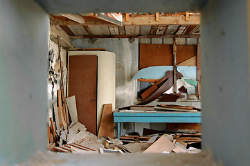 Image showing ramshackled room with boarded up window 