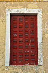 Image showing closed window shutter and chipped wall