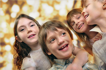 Image showing holiday portrait of happy children against bright golden backgro