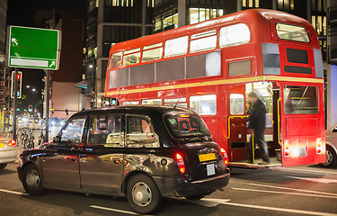 Image showing Red vintage bus and classic style taxi in London. 