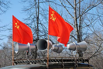 Image showing red flags and megaphones on the roof of a car