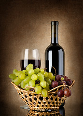 Image showing Wine and grapes in basket