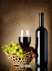 Image showing Wine and grapes on a old background