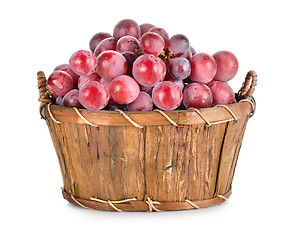 Image showing Dark blue grapes in a wooden basket isolated