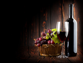 Image showing Wine on the dark wooden background