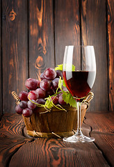 Image showing Wine glass and grapes in a basket