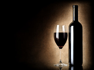 Image showing Wine bottle and wineglass on a old background