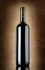 Image showing Wine bottle on a old canvas