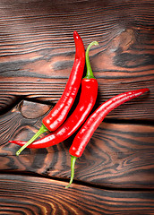 Image showing Chili on a wooden background