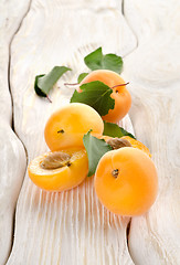Image showing Apricots and leaves on a table