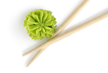 Image showing Wooden chopsticks and wasabi isolated