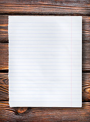 Image showing Lined paper on dark table