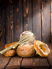 Image showing Bread on a old wooden boards