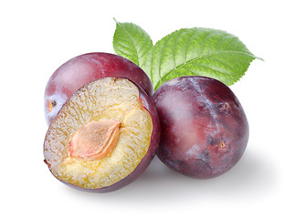 Image showing Three plums with leaves