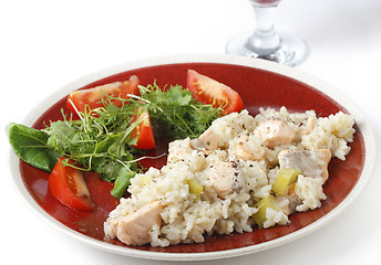 Image showing Salmon risotto with a glass