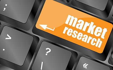 Image showing key with market research text on laptop keyboard, business concept