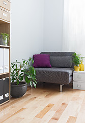 Image showing Corner of a living room with gray armchair and plants