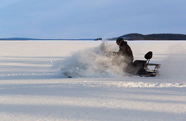 Image showing man riding a snowmobile