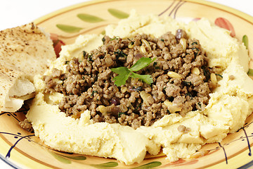 Image showing Hummus with meat and pine nuts