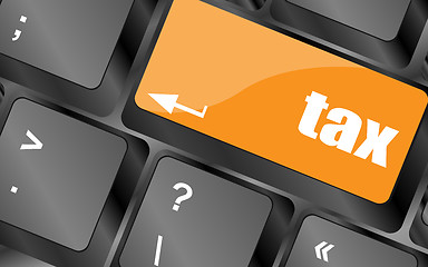 Image showing tax word on laptop keyboard key, business concept