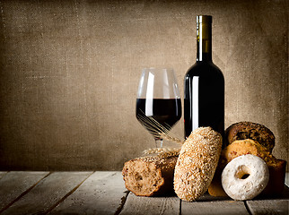 Image showing Red wine and assortment of bread